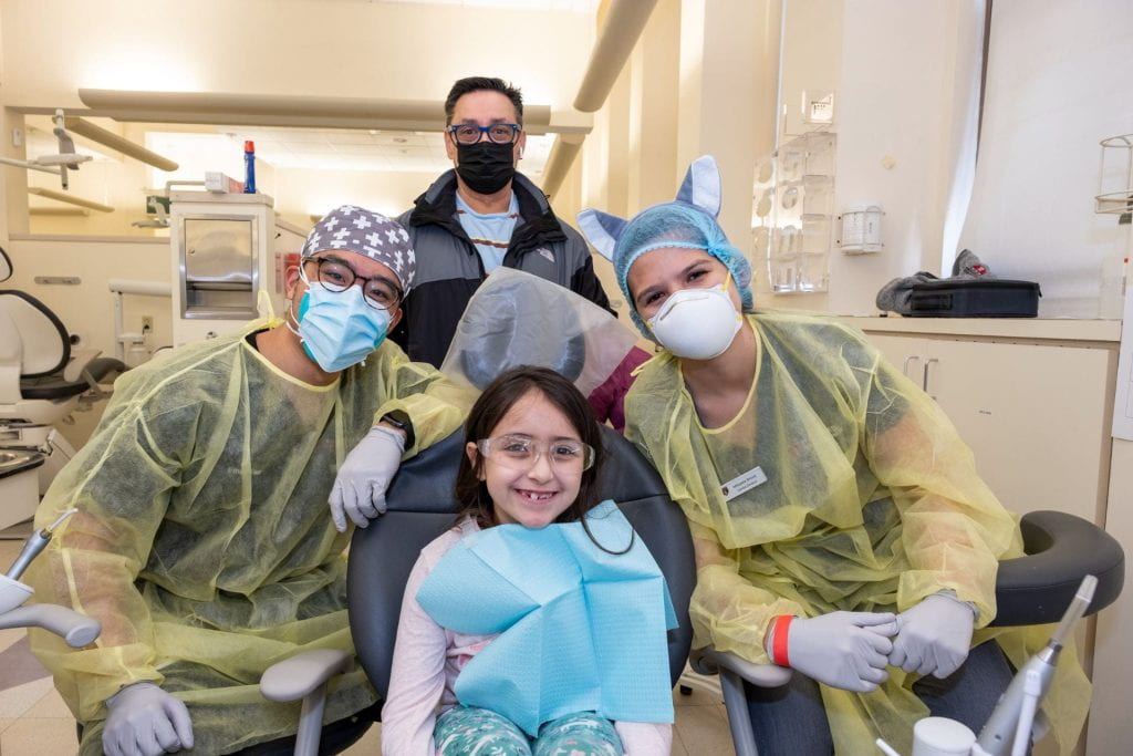 Two dentists with patient