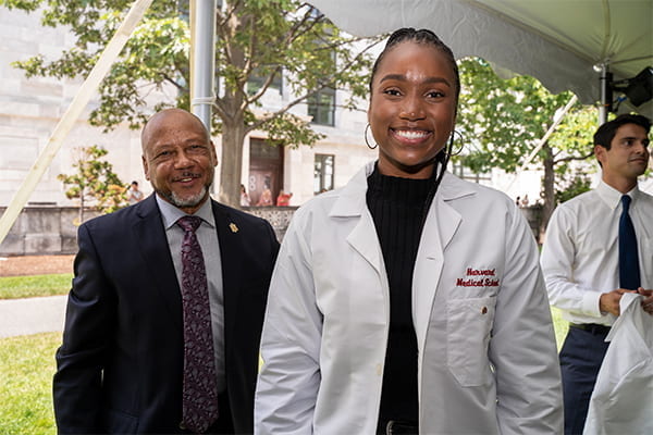 Student and faculty pose for photo at annual White Coat Ceremony