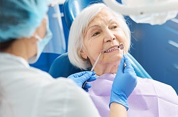 A close up of an elderly women having a dental exam.